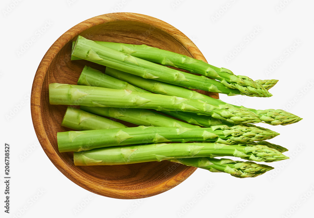 Fresh green shoots of asparagus in a wooden bow Fresh green shoots of asparagus in a wooden bow