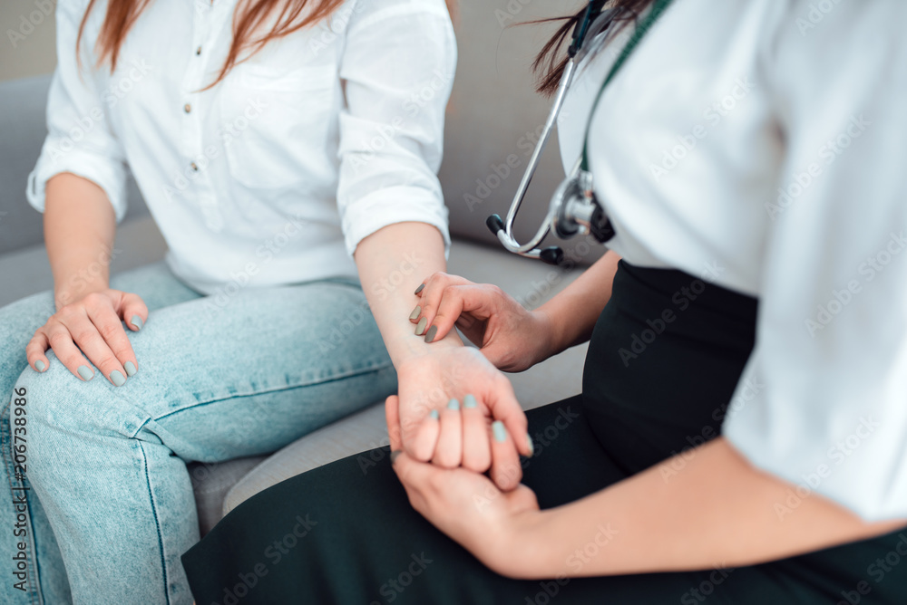 Fototapeta premium Family doctor check heart rate of a young mother