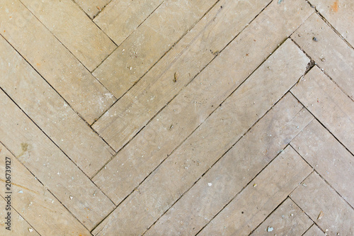 A close-up of an old gray faded parquet covered with dust and dirt. Result of repair. Cleaning and cleaning required