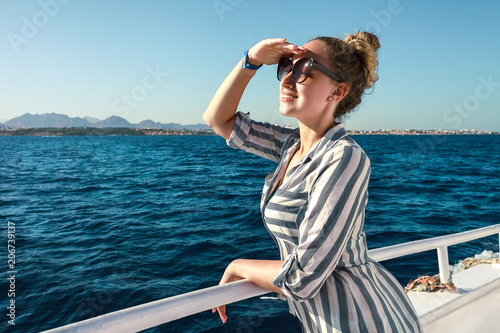 pretty girl with sunglasses happy looking forward  while travels on yacht © Dashskala