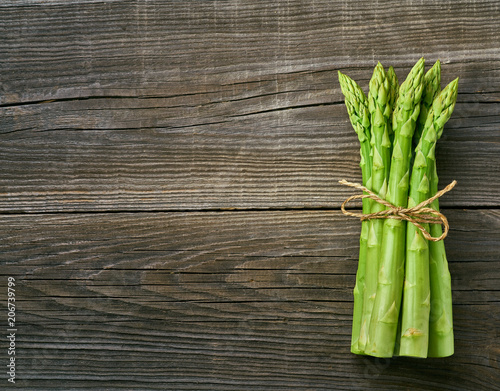 Fresh green shoots of asparagus on a gray wooden background