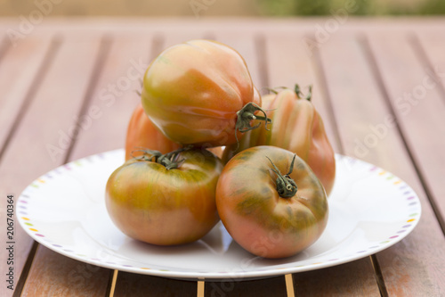 tomatoes on a plate on the table