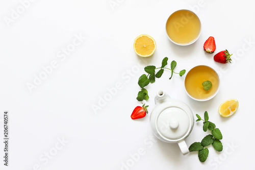 Herbal tea from mint and strawberry with lemon other herbs on a white background. T photo