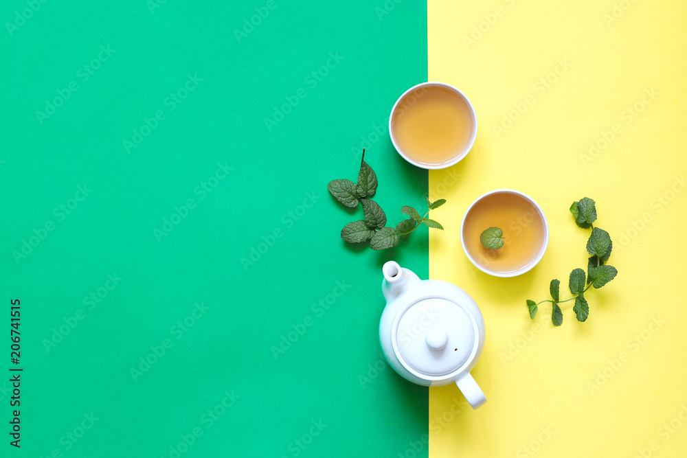 Herbal tea made of thyme and other herbs on yellow background.