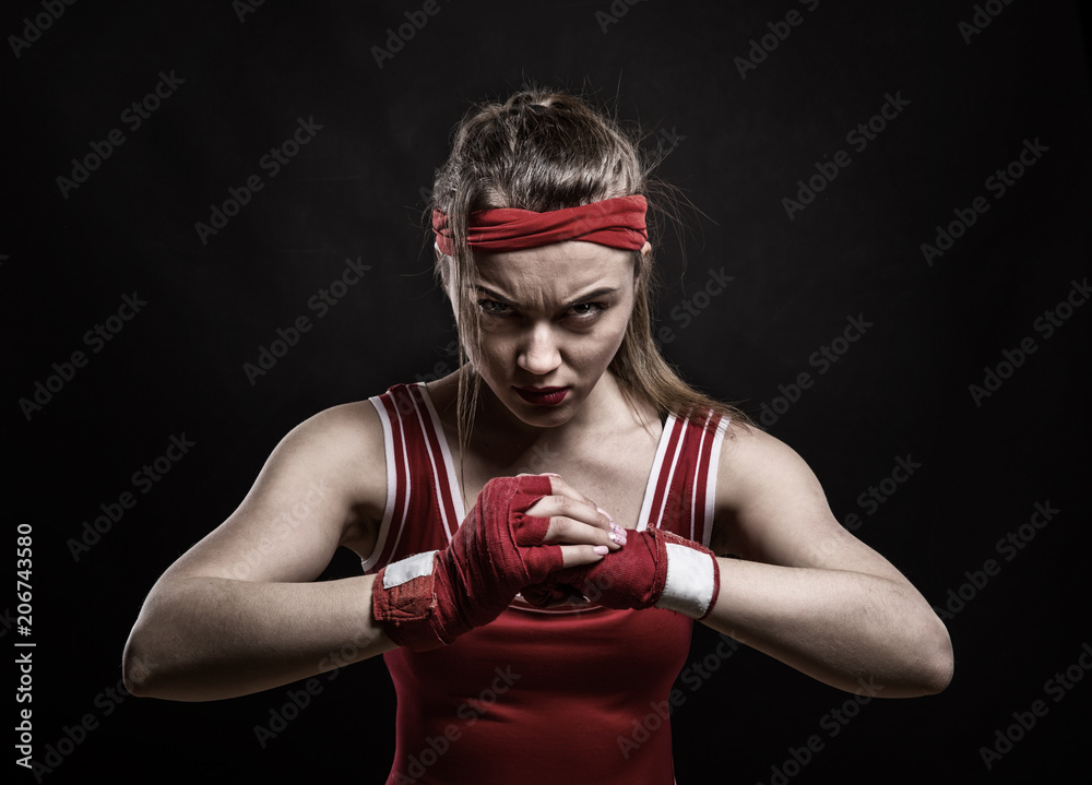 Female kickboxer training in gym, boxing workout