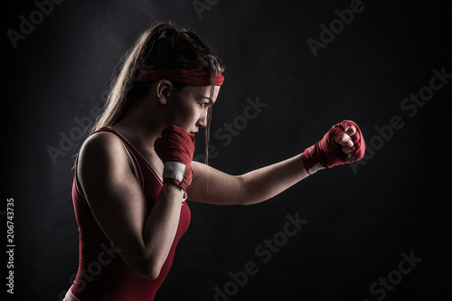 Female boxer in red boxing bandages and sportswear © Nomad_Soul