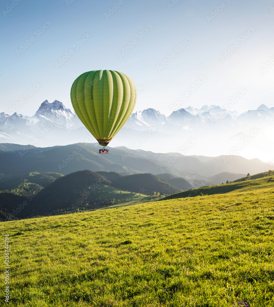 Naklejka premium Air ballon above mountains at the summer time. Concept and idea of adventure