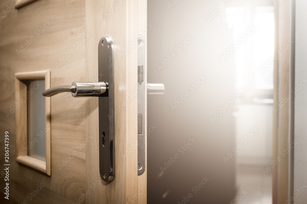 Half-open door to the room. The glow of the sun coming out of the room, brightness. Half-open door to the room. The glow of the sun coming out of the room, brightness.