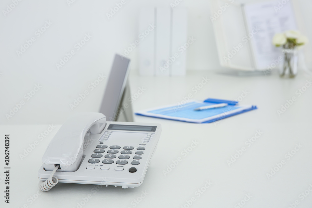Stationary phone on reception desk in hospital Stationary phone on reception desk in hospital