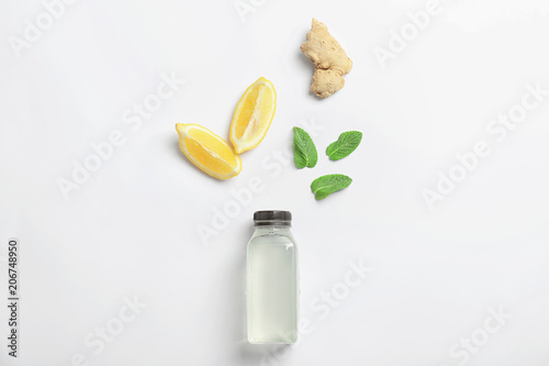 Flat lay composition with delicious natural lemonade on white background