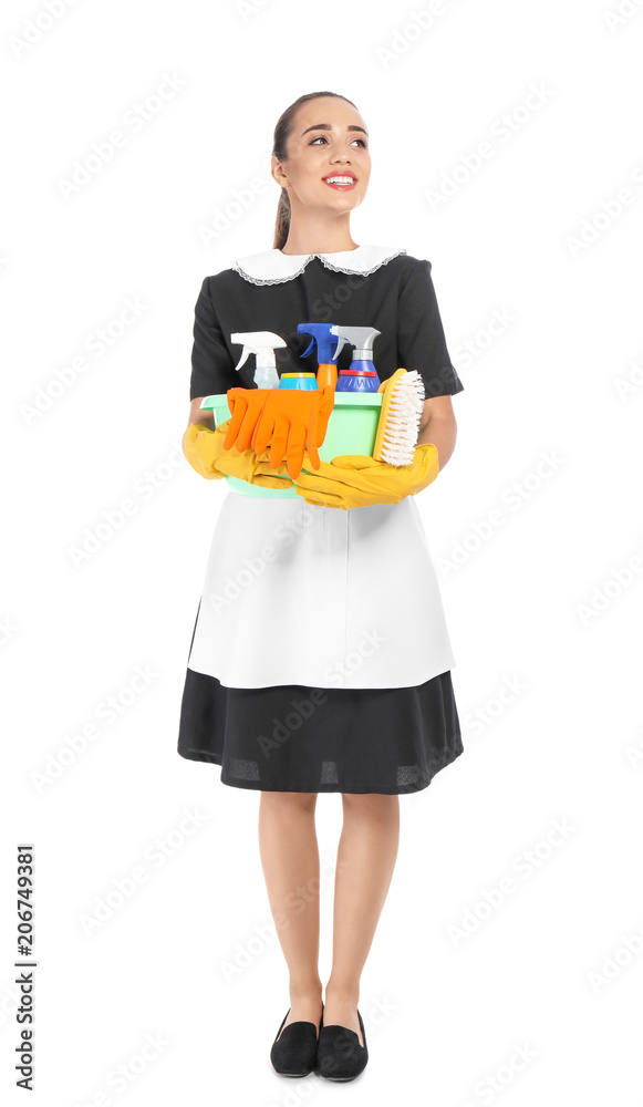 Young chambermaid holding plastic basin with detergents on white background Young chambermaid holding plastic basin with detergents on white background