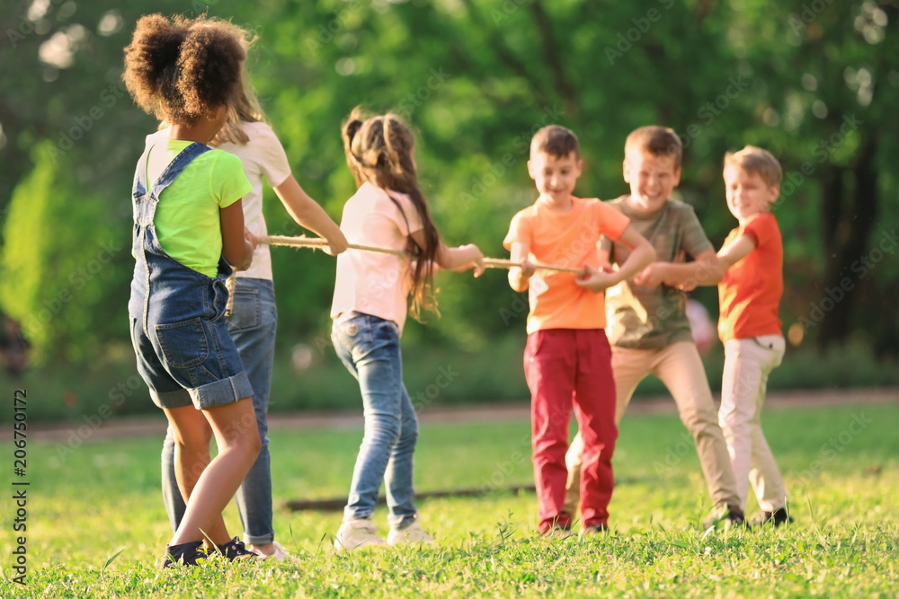 Cute little children playing with rope outdoors on sunny day Cute little children playing with rope outdoors on sunny day