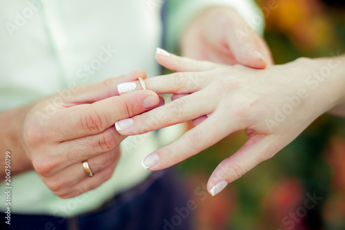 wedding ceremony puts a ring on the finger of the groom and the bride offering an engagement happy moment