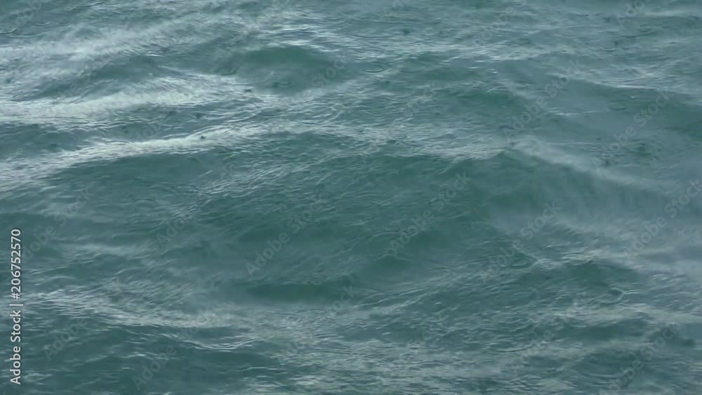 Rain drops fall on the sea surface. Rain drops fall on the sea surface.