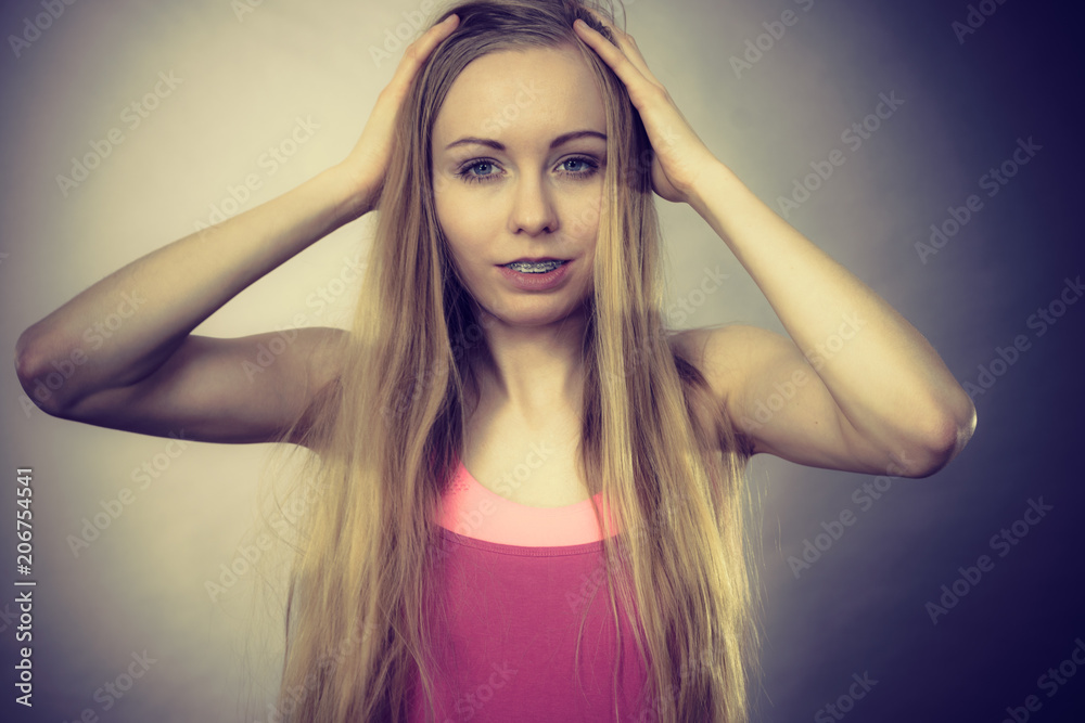 Young woman touching her long hair