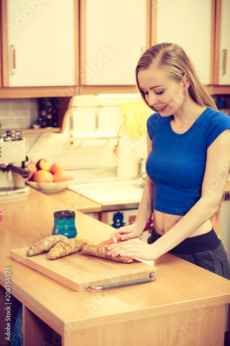 Woman preparing healthy breakfast making sandwich
