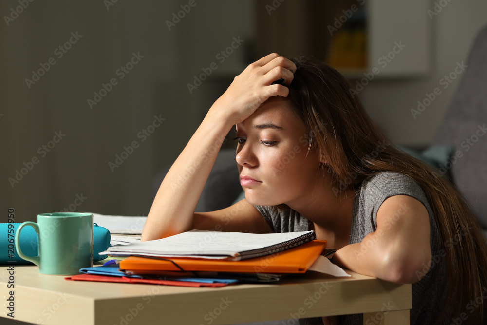 Tired student trying to study in the night - obrazy, fototapety, plakaty 