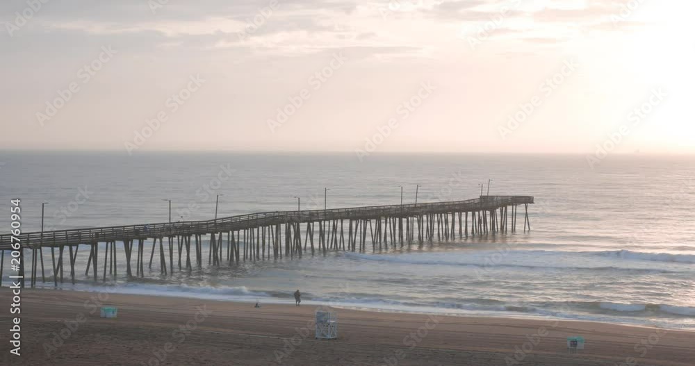 fisherman in action in Virginia beach at sunrise fisherman in action in Virginia beach at sunrise