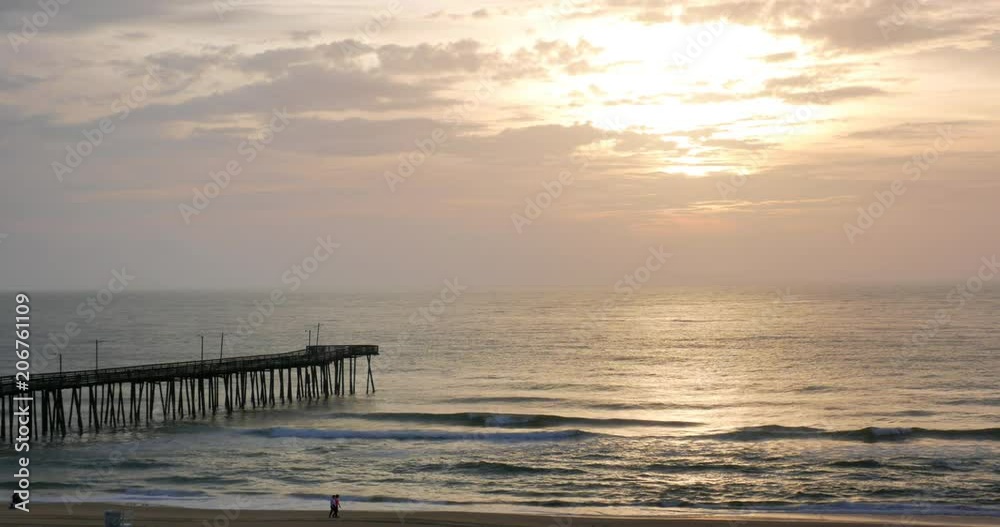 People walking on the beach at sunrise, Virginia beach, VA, USA People walking on the beach at sunrise, Virginia beach, VA, USA