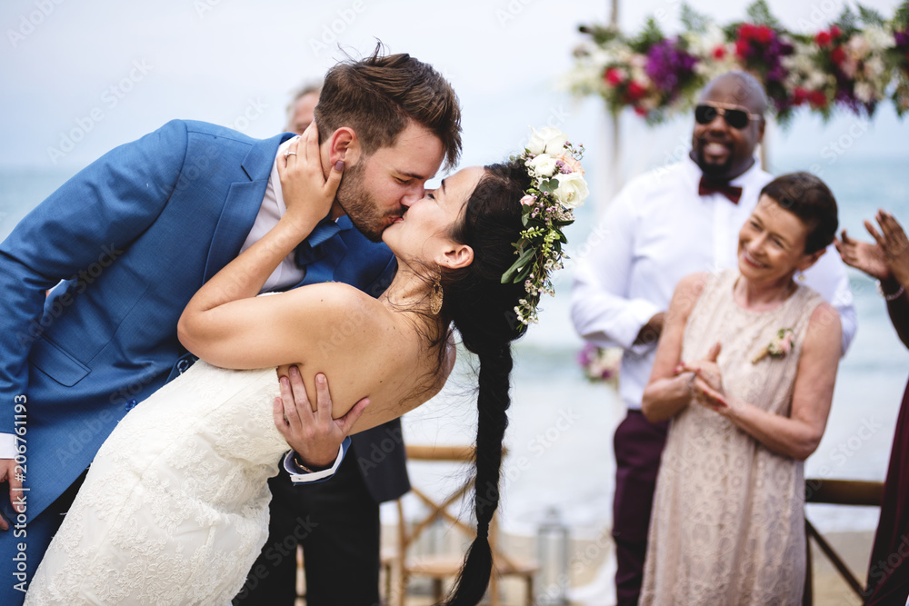 Fototapeta premium Cheerful newlyweds at beach wedding ceremnoy