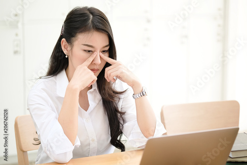 Shot of an attractive young asian businesswoman serious working on her office computer