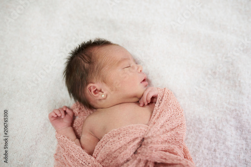 Newborn sleeping on soft blanket © PixieMe