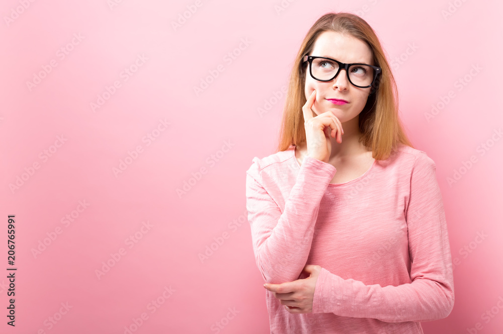 Young woman in a thoughtful pose on a solid background Young woman in a thoughtful pose on a solid background