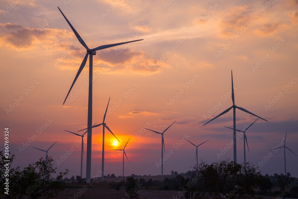 Wind turbines generating electricity in evening