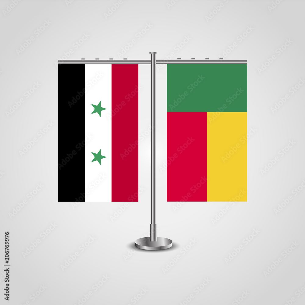 Table stand with flags of Syria and Benin.Two flag. Flag pole. Symbolizing the cooperation between the two countries. Table flags