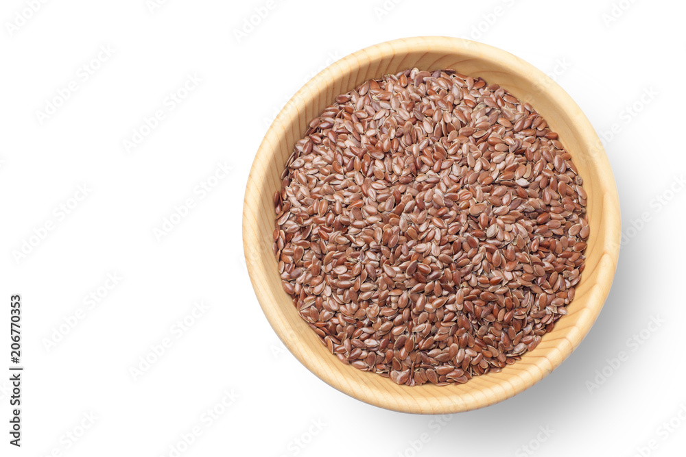 Flax seeds in a wooden bowl on white background Flax seeds in a wooden bowl on white background