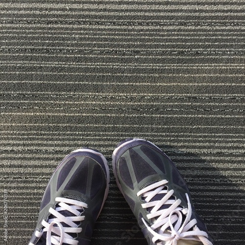 Female in Purple Sneakers Shoes Isolated. Top View. Woman Wear Runner Sneakers Urban on Carpet Background