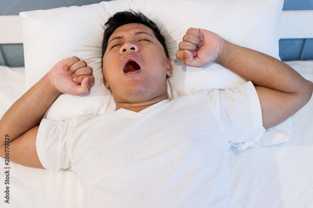 Man sleeping on white bed with an Open Mouth. Health concept. Man sleeping on white bed with an Open Mouth. Health concept.