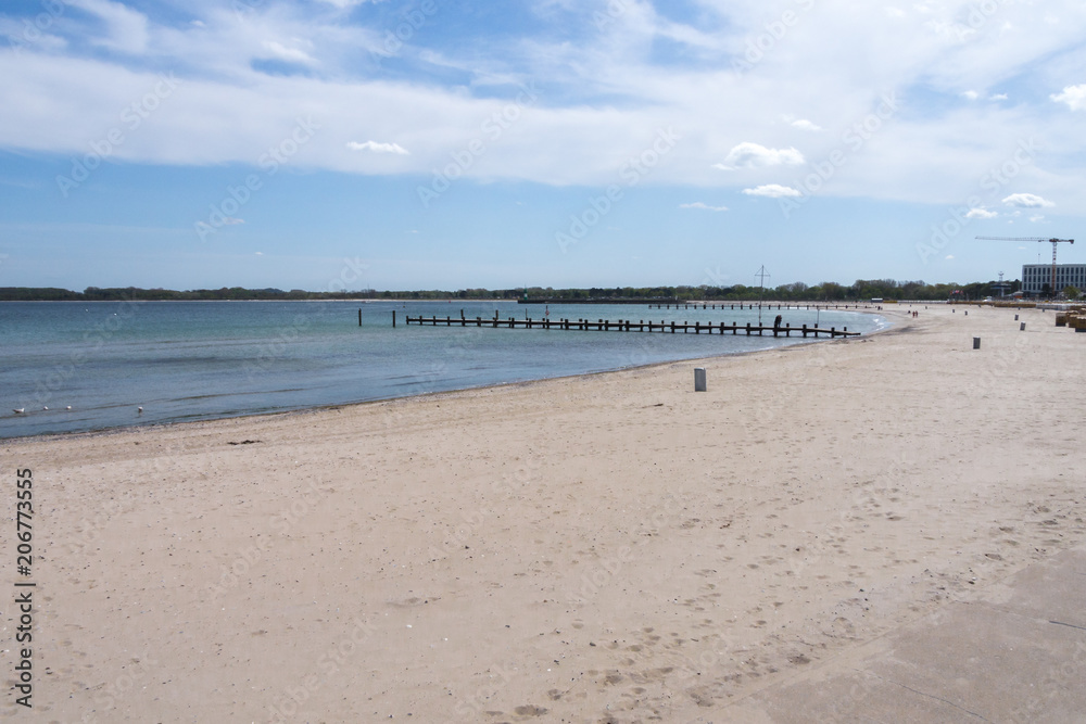beach on the baltic sea with a view of two wooden bridges