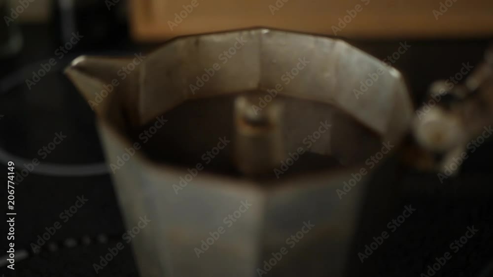 Coffee steaming in a percolator. Slow motion hand held.