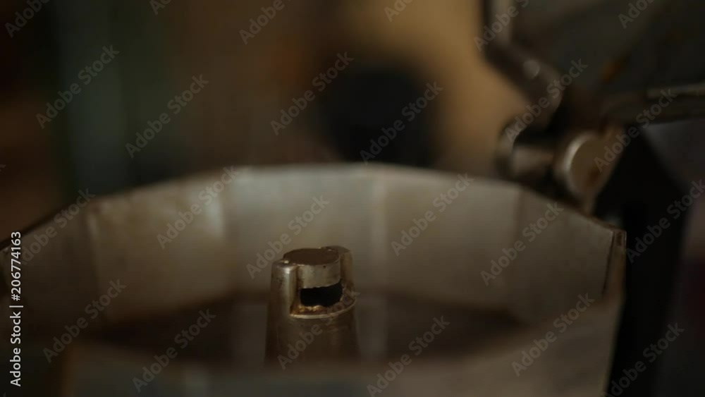 Coffee steaming fresh in a percolator. Slow motion hand held.