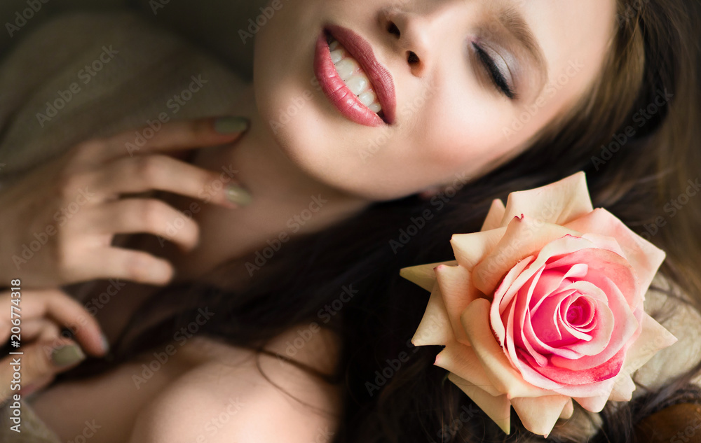 close portrait of beautiful young woman in bed with rose. close portrait of beautiful young woman in bed with rose.