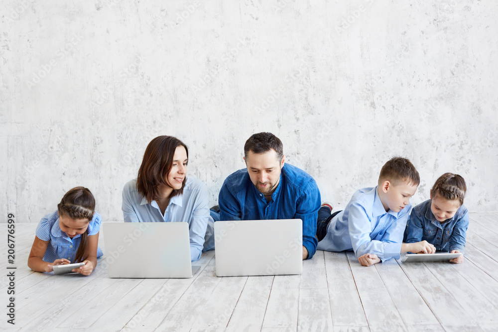 Large family with gadgets. Parents and children at laptops Large family with gadgets. Parents and children at laptops