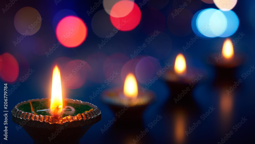 Happy Diwali - Diya lamps lit during celebration Happy Diwali - Diya lamps lit during celebration