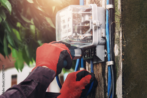 electrician installing watthour meter at home photo