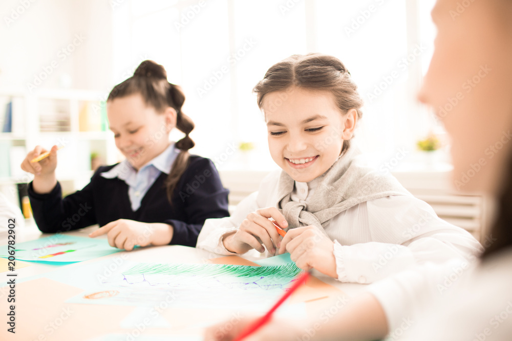 Happy schoolgirls satisfied by their drawing pictures Happy schoolgirls satisfied by their drawing pictures