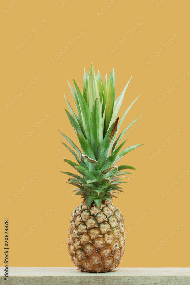 Pineapple with yellow background.