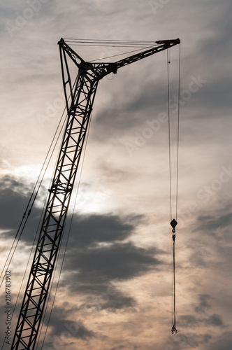 Industrial construction crane at sunset