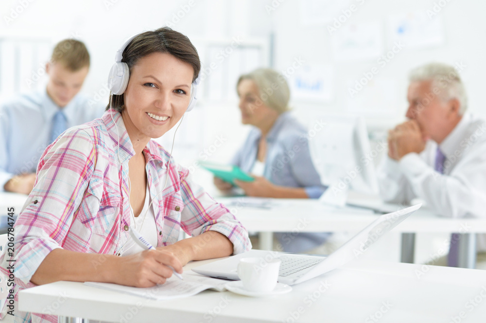 Young woman with headache working