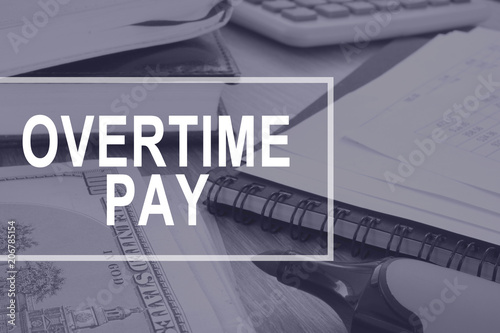 Overtime pay. Office desk with calculator and documents.