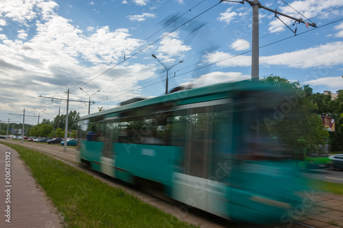 The motion of a blurred streetcar in the daytime.