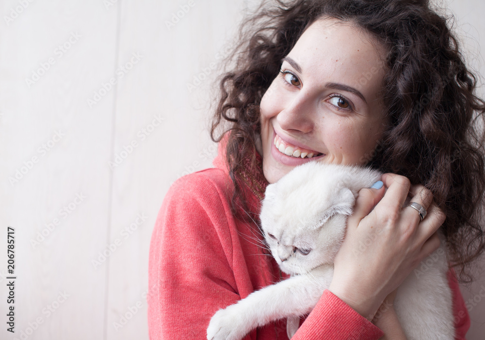 Portrait of young beauty brunette holding gorgeous white cat. Woman love her cat. Family concept. Closed eyes Portrait of young beauty brunette holding gorgeous white cat. Woman love her cat. Family concept. Closed eyes