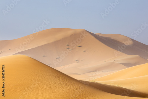 orange dunes and blue sky in Sahara desert in Morocco
