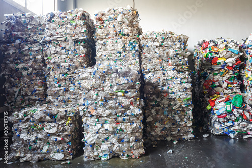 Plastic bales at the waste processing plant. Separate garbage collection. Recycling and storage of waste for further disposal. Business for sorting and processing of waste. photo