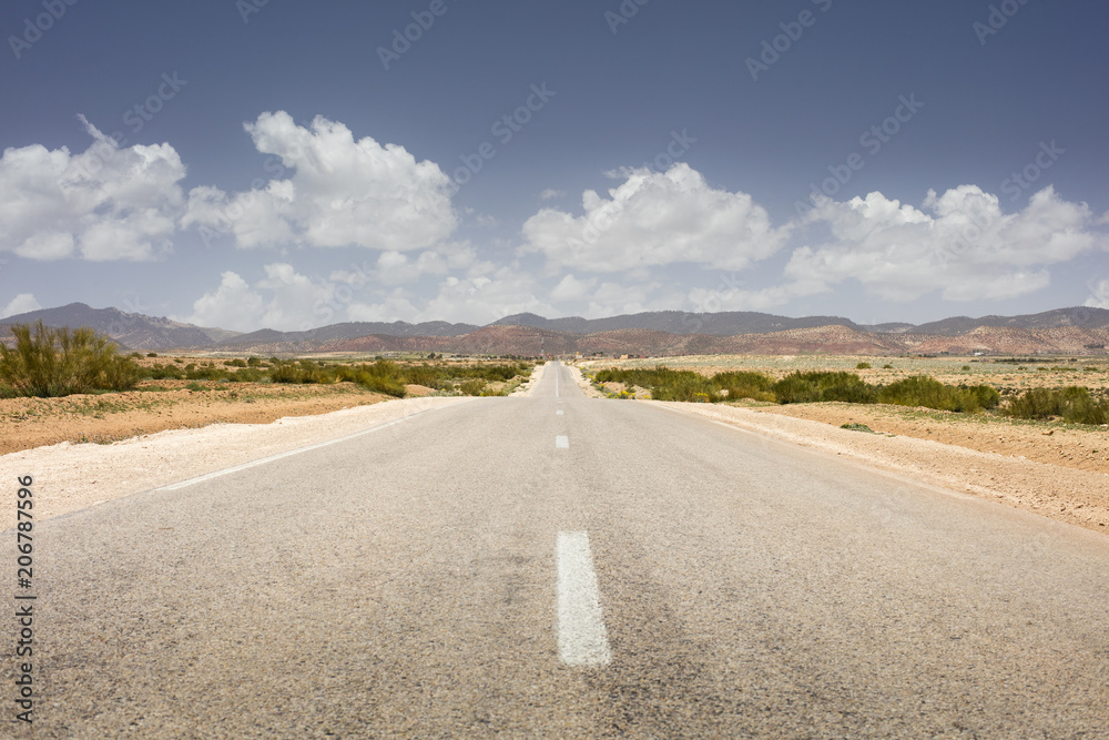 alone empty asphalt road with clouds in Morocco alone empty asphalt road with clouds in Morocco