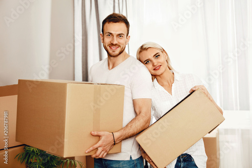 Moving House. Man And Woman Holding Boxes © puhhha